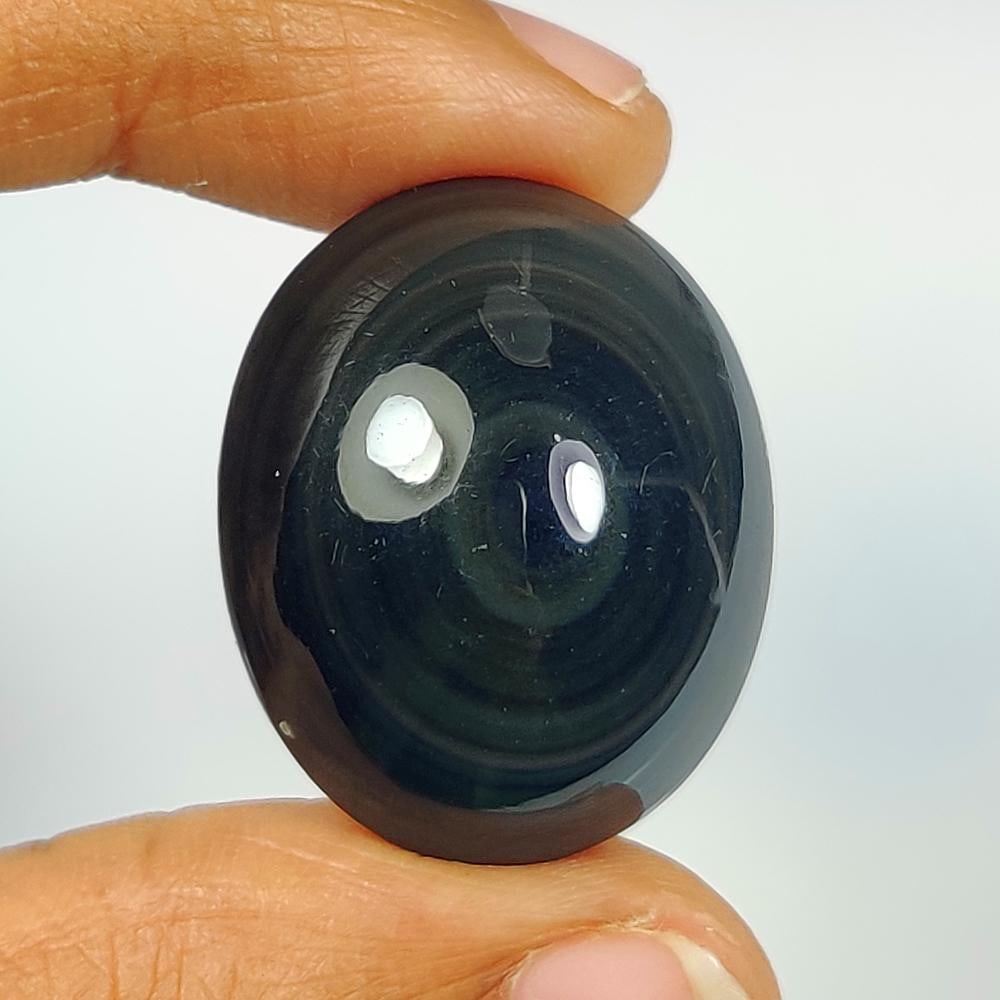 34.40 Ct Natural Obsidian Oval Cab: Weight - 34.40 Ct / Size - 25.00 x 19.90 x 11.80 mm / Shape - Oval Cab / Clarity - Opaque / Origin - Brazil / Treatment - None
