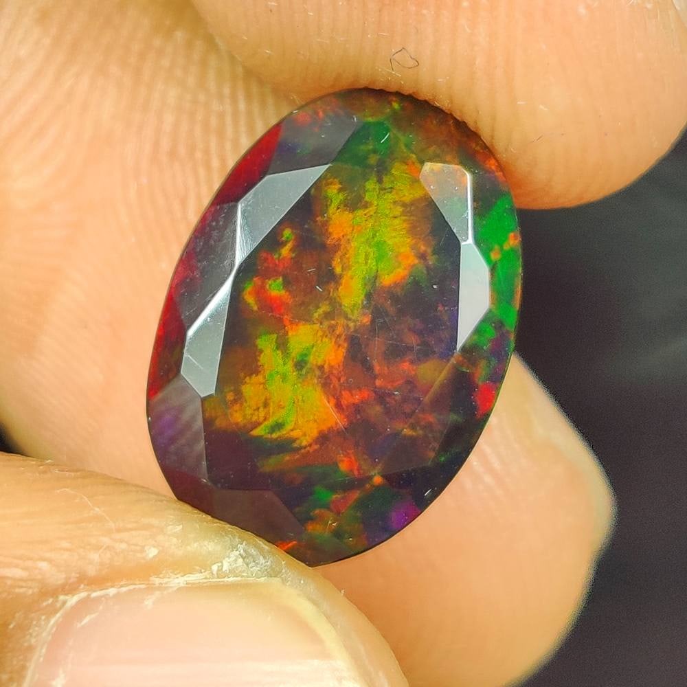 4.64 Ct Natural Black Fire Opal Oval Cut: Weight - 4.64 Ct / Size - 14.60 x 10.20 x 7.40 mm / Shape - Oval cut / Color - Black / Clarity - Translucent / Origin - Ethiopia / Treatment - Color Smoked