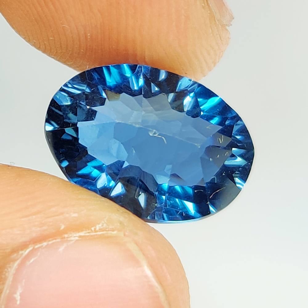 7.83 Ct Natural London Blue Topaz Oval Football Cut: Weight : 7.83 Ct / Dimensions : 14.10 x 10.00 x 8.00 mm / Shape : Oval Football Cut / Color : Blue / Transparency : Transparent / Treatment : Irradiated
