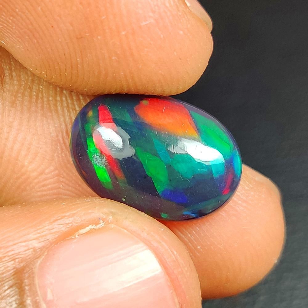 3.33 Ct Natural Black Fire Opal Oval Cab: Weight - 3.33 Ct / Dimensions -14.20 x 9.90 x 4.70 mm / Shape - Oval Cab / Color - Black / Clarity - Translucent / Origin - Ethiopia / Treatment - Color Smoked