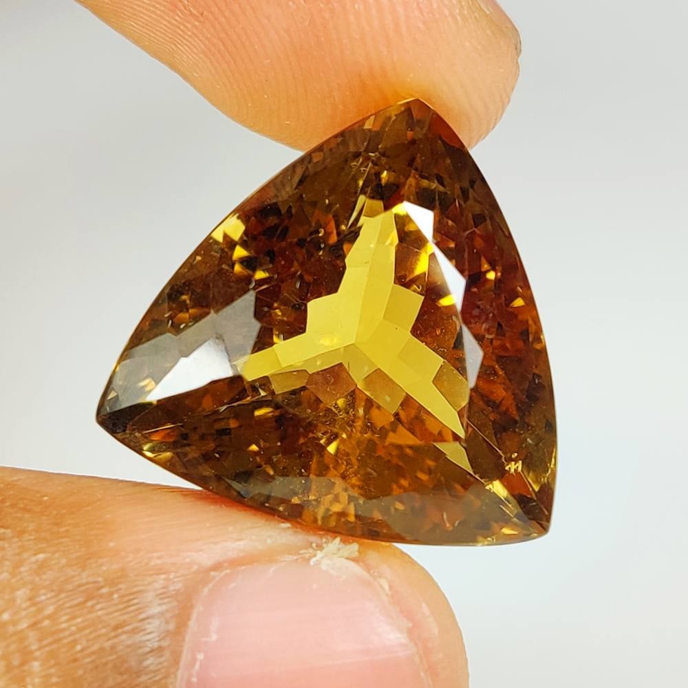 31.62 Ct Natural Yellow Citrine Trillion Cut: Weight - 31.62 Ct / Size -21.00 x 20.60 x 14.40 mm / Shape - Trillion Cut / Color - Yellow / Clarity - VVS / Origin - Brazil / Treatment - Heated