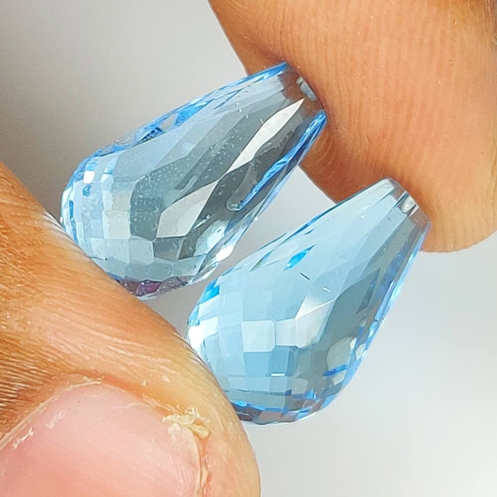 19.73 Ct Natural Blue Topaz Pear Drop Pair: Weight - 19.73 Ct / Dimensions - 15.30 x 8.90 x 8.90 mm / 2 Pc's / Shape & Cut - Pear Drop / Color - Blue / Transparency - VVS / Origin - Brazil / Comments - Irradiated