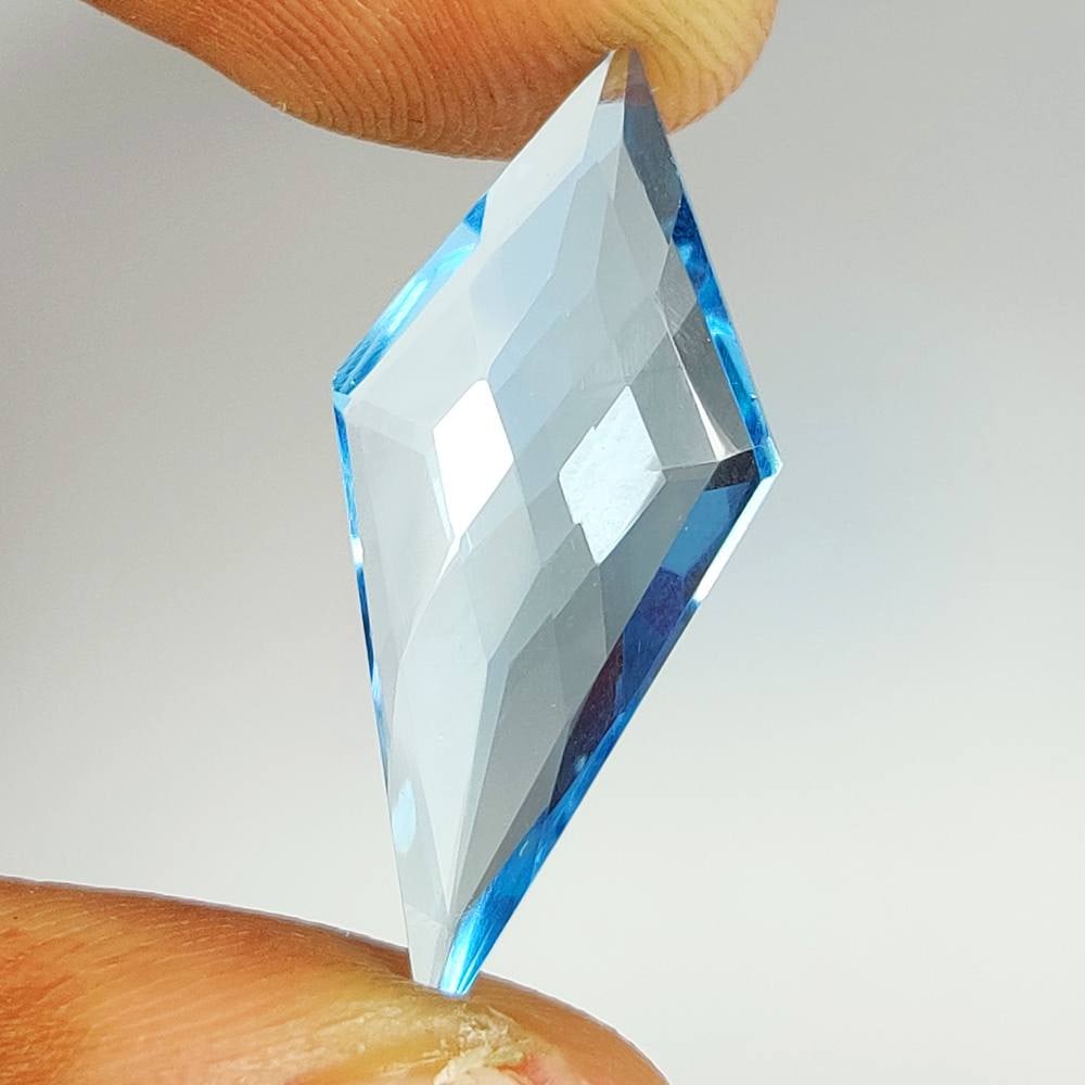 9.06 Ct Natural Blue Topaz Fancy Cut: Weight - 9.06 Ct / Dimensions - 28.00 x 12.40 x 4.90 mm / Shape & Cut - Fancy cut / Color - Blue / Transparency - VVS / Origin - Brazil / Comments - Irradiated