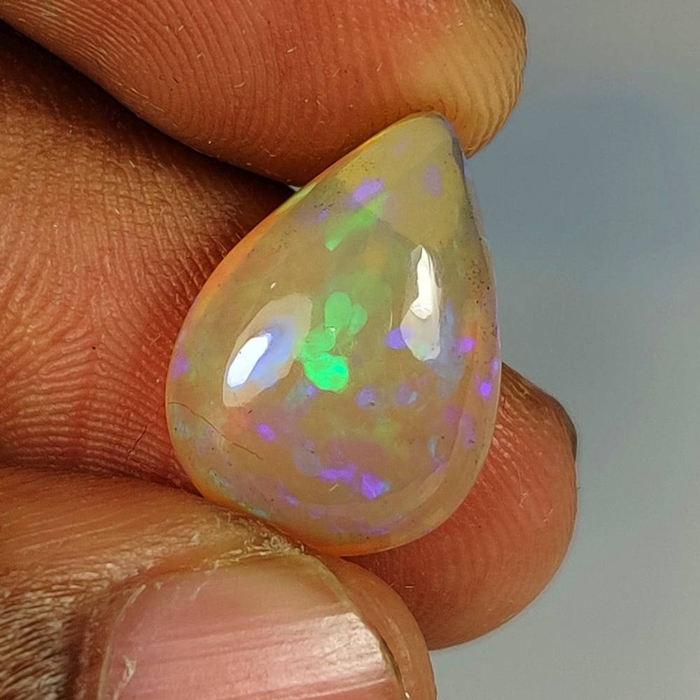 5.51 Ct Natural Multicolor Welo Opal Top Fire Pear Cab: Weight - 5.51 Ct / Dimensions - 17.00 x 12.00 x 6.50 mm / Shape - Pear Cab / Color - Multicolor / Clarity - Translucent / Origin - Ethiopia / Treatment - None