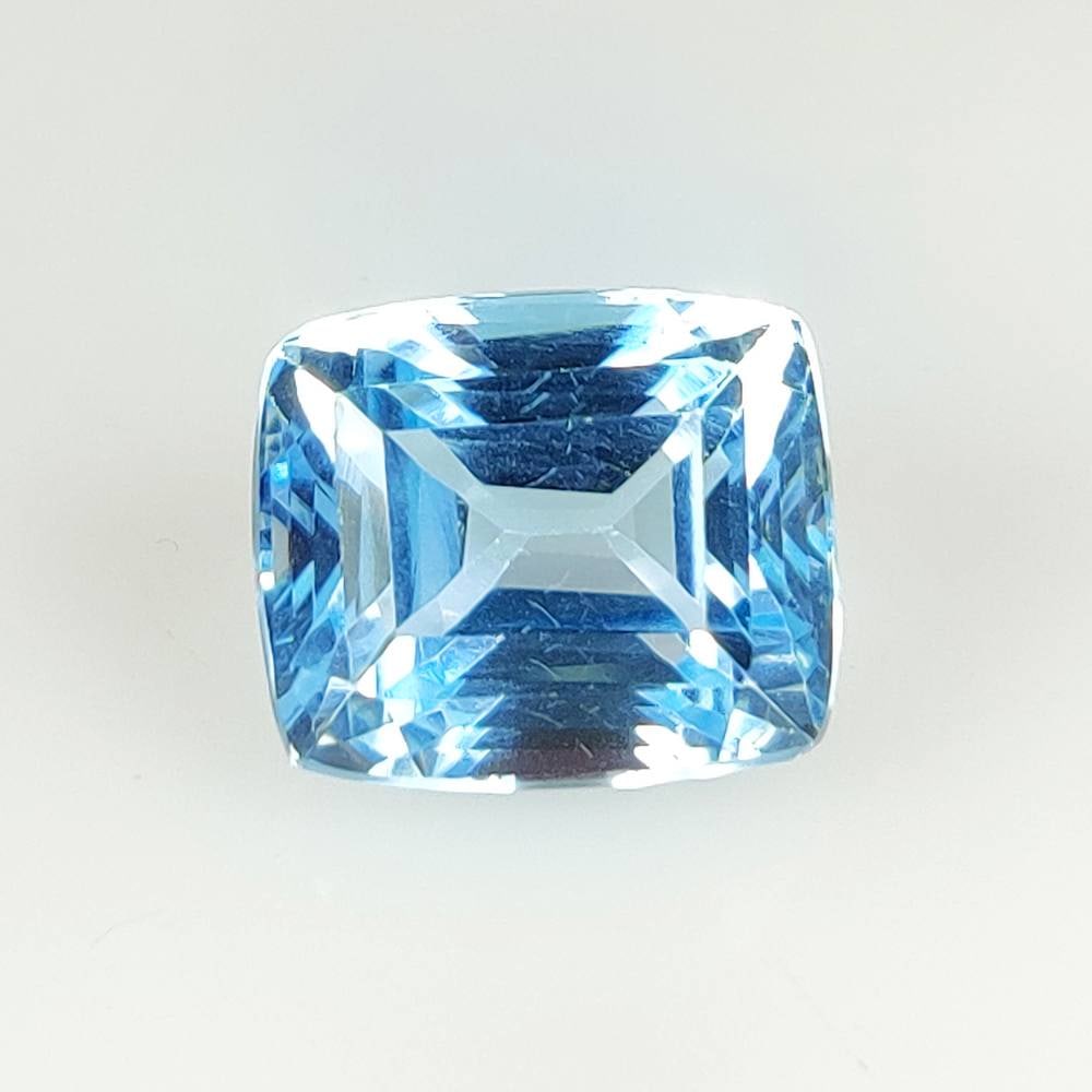 16.08 Ct Natural Blue Topaz Cushion Cut: Weight - 16.08 Ct / Dimensions - 14.10 x 12.10 x 10.00 mm / Shape - Cushion Cut / Color - Blue / Clarity - VVS / Origin - Brazil / Treatment - Irradiated