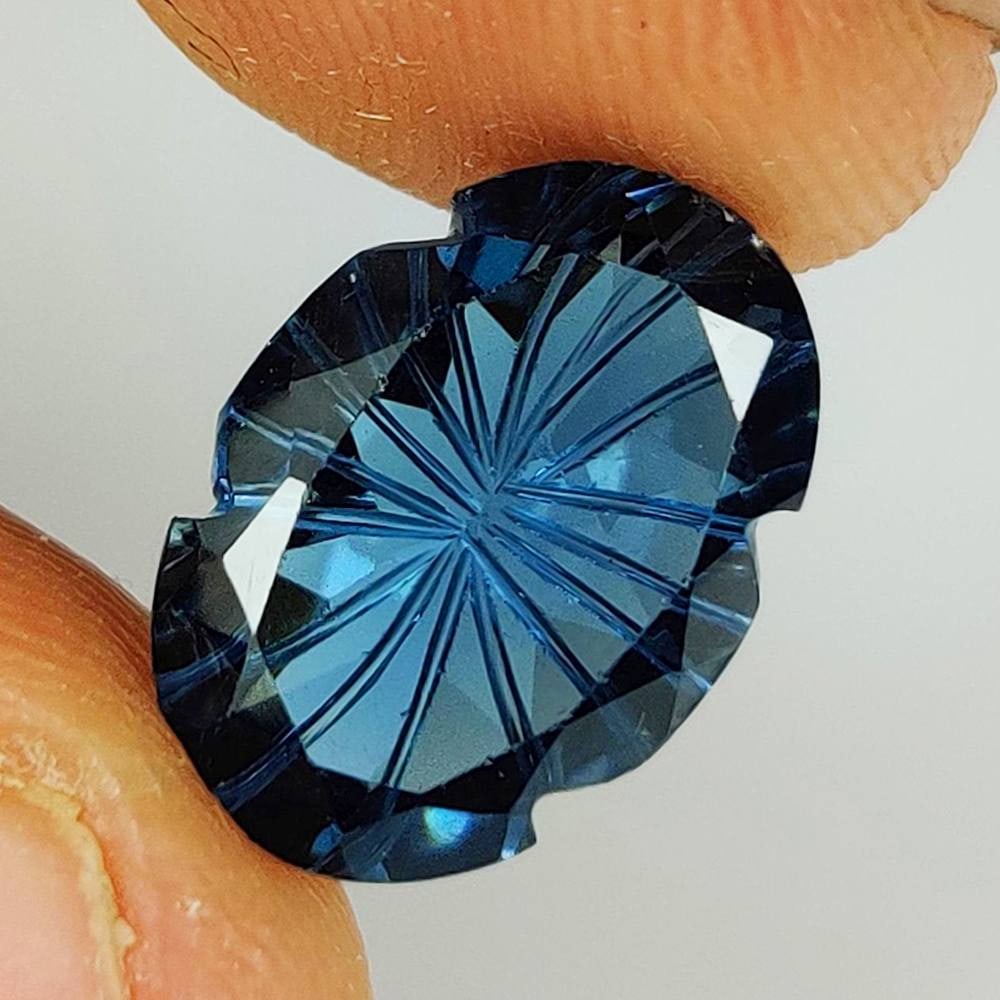5.86 Ct Natural London Blue Topaz Oval Carving Cut: Weight - 5.86 Ct / Size - 14.10 x 10.00 x 5.50 mm / Shape - Oval Carving Cut / Color - Deep Blue / Clarity - VVS / Origin - Brazil / Treatment - Irradiated