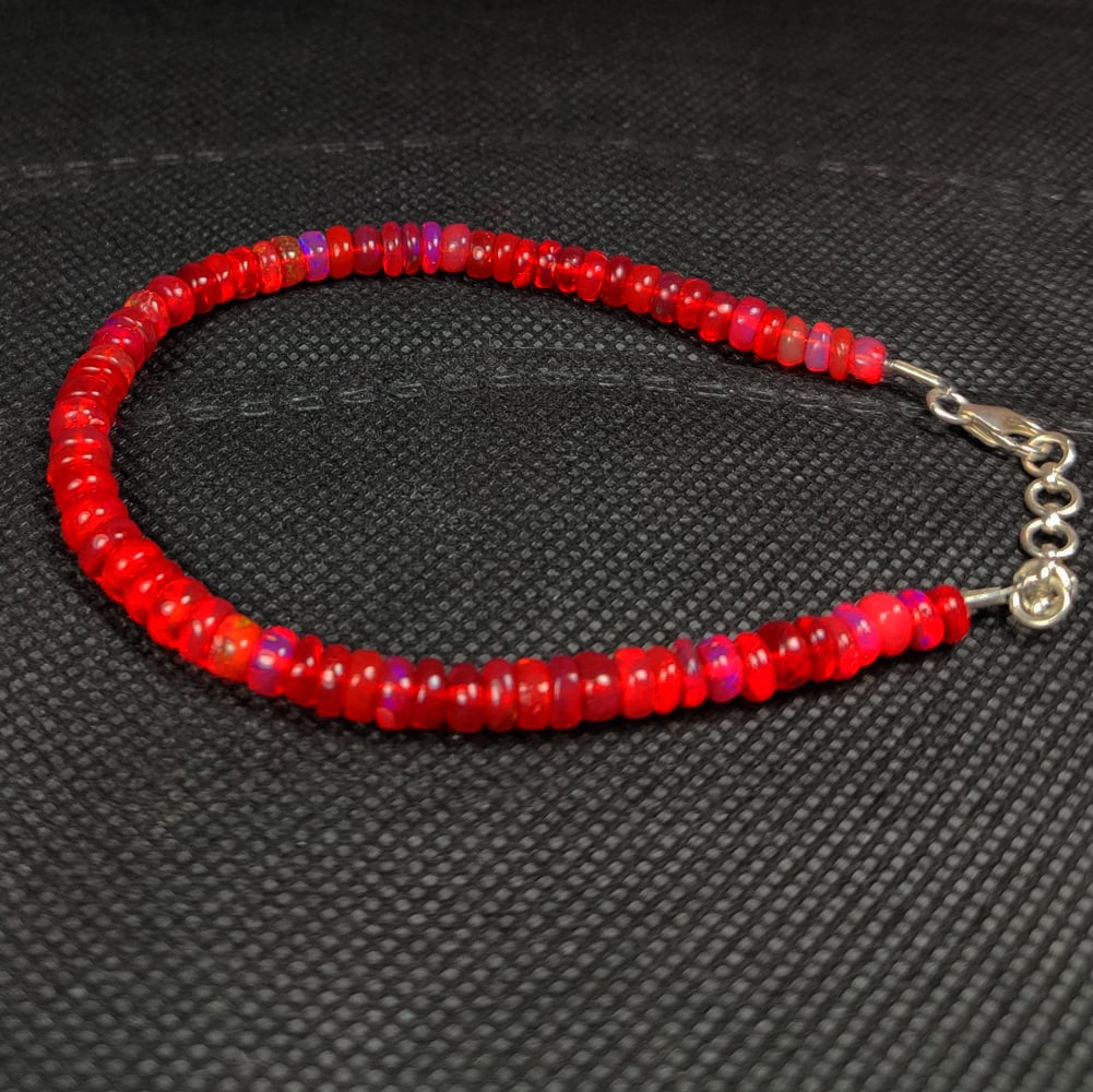 27.20 Ct Natural Orange Fire Opal Round Beads Bracelet: Weight - 27.20 Ct / Dimensions - 4.60 - 5.20 mm / 70 Pc's / 8.75" inches / Shape - Round Beads / Color - Orange / Clarity - Translucent / Origin - Ethiopia / Treatment - Color Heated