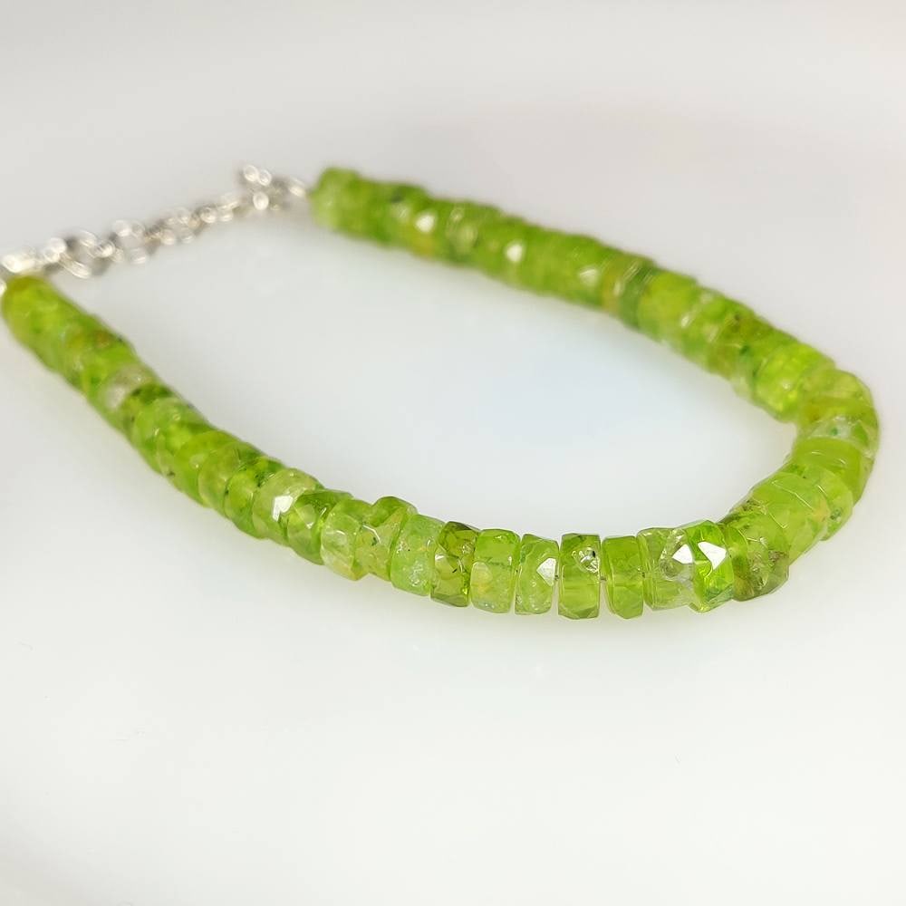 55.21 Ct Natural Green Peridot Round Drilled Beads Bracelet: Weight - 55.21 Ct / Dimensions -5.20 - 6.10 mm / 53 pc's / 7.5' Inches / Shape - Round Beads / Transparency - Transparent/ Origin - Pakistan / Treatment - None