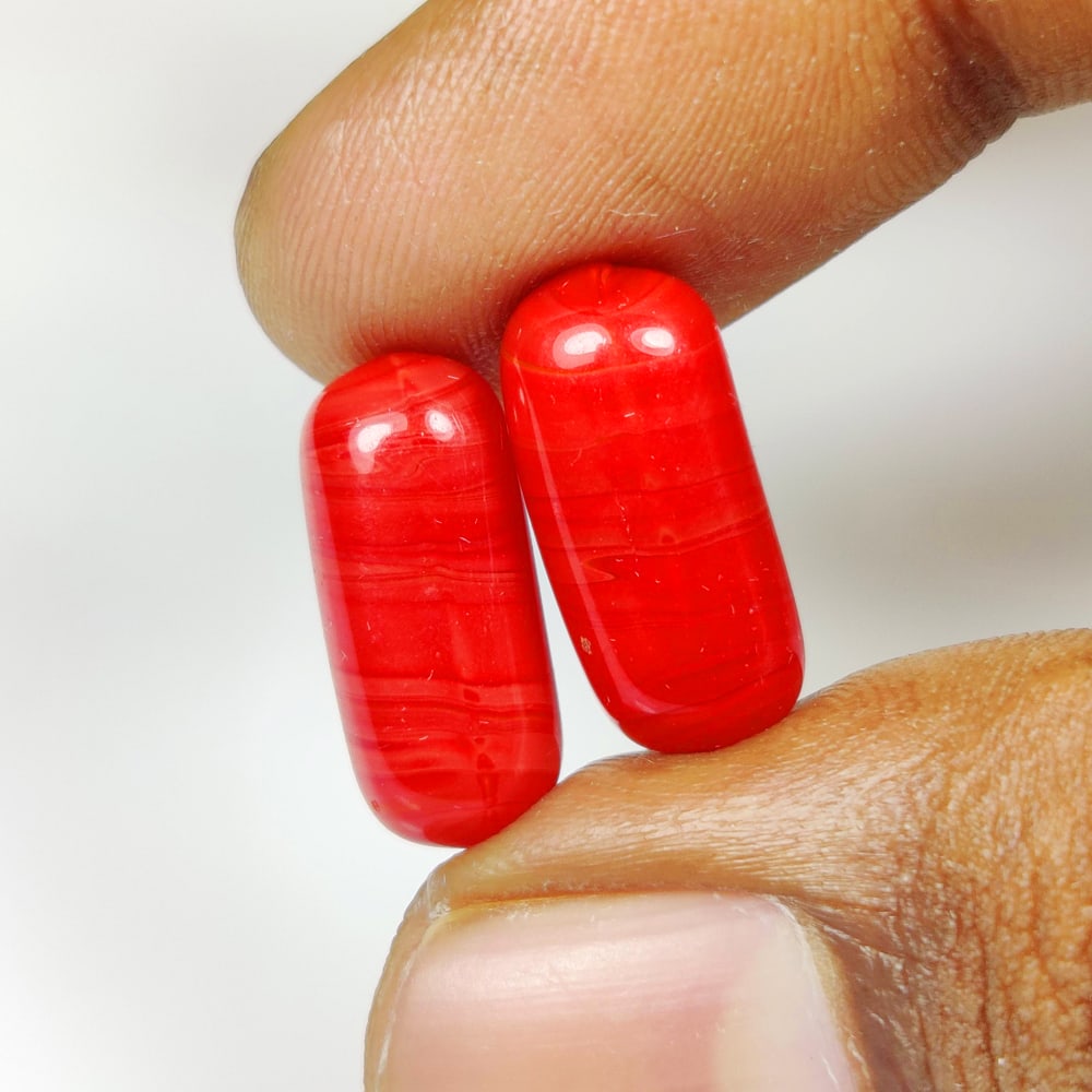 15.10 Ct Natural Red Coral Cabsule Cab Pair: Weight - 15.10 Ct / Dimensions - 16.90 x 7.30 x 7.30 mm / 2 PC's / Shape - Cabsule Cabochon / Color - Red / Clarity - Opaque / Origin - Italy / Treatment - None