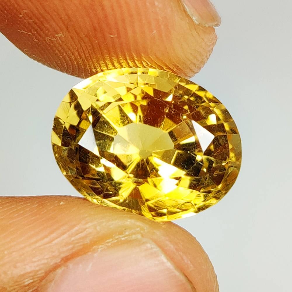 8.35 Ct Natural Yellow Citrine Oval Cut: Weight - 8.35 Ct / Dimensions - 14.30 x 11.60 x 10.10 mm / Shape - Oval Cut / Color - Yellow / Clarity - VVS / Origin - Brazil / Treatment - Heated