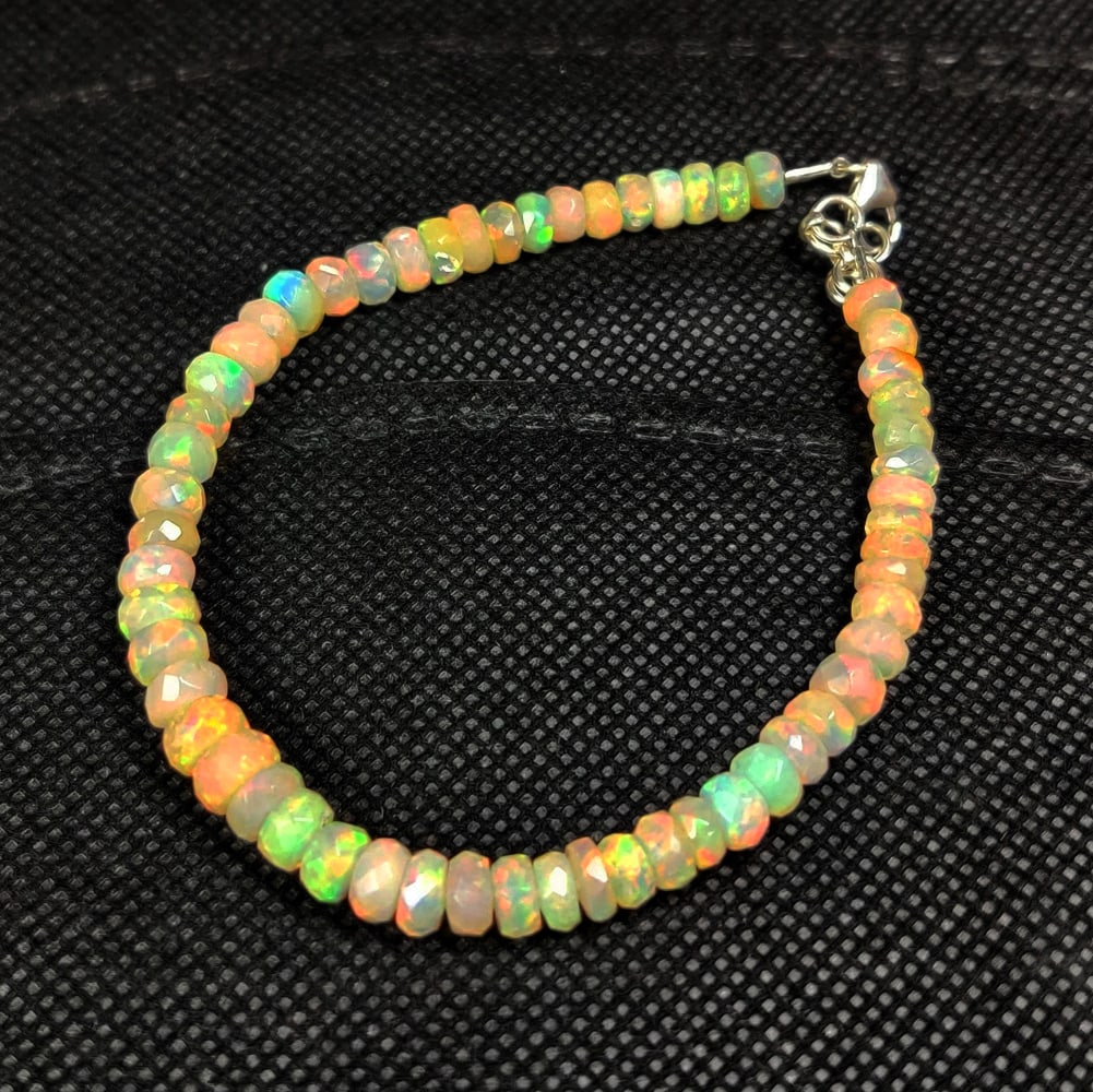 30.80 Ct Natural Multicolor Welo Opal Flash Fire Round Beads Bracelet: Weight - 30.80 Ct / Dimensions - 4.90 - 6.30 mm / 57 Pc's / 9" inches / Shape & Cut - Round Beads / Color - Multicolor / Transparency - Translucent / Origin - Ethiopia / Comments - None