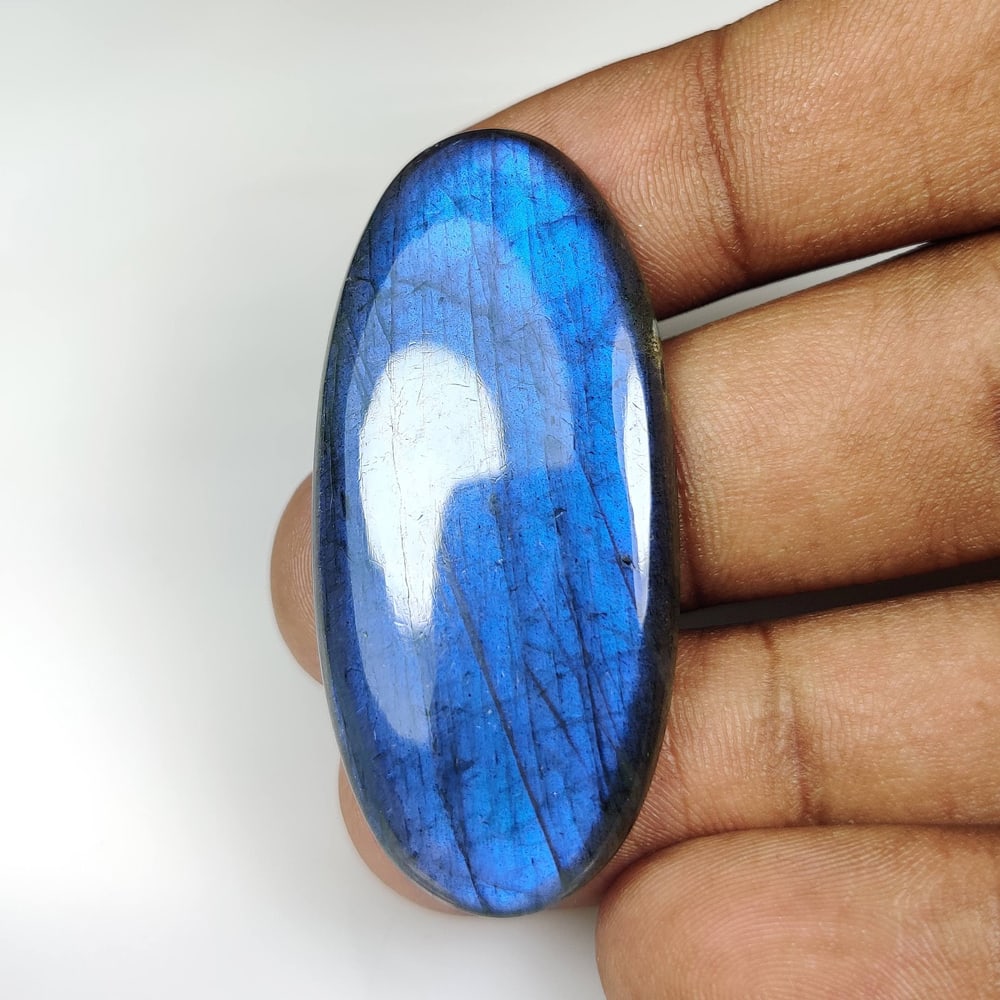 56.89 Ct Natural Blue Shaded Labradorite Oval Cab: Weight - 56.89 Ct / Size - 48.00 x 21.00 x 5.90 mm / Shape - Excellent Oval Cab / Clarity - Opaque / Origin - Africa / Treatment - None