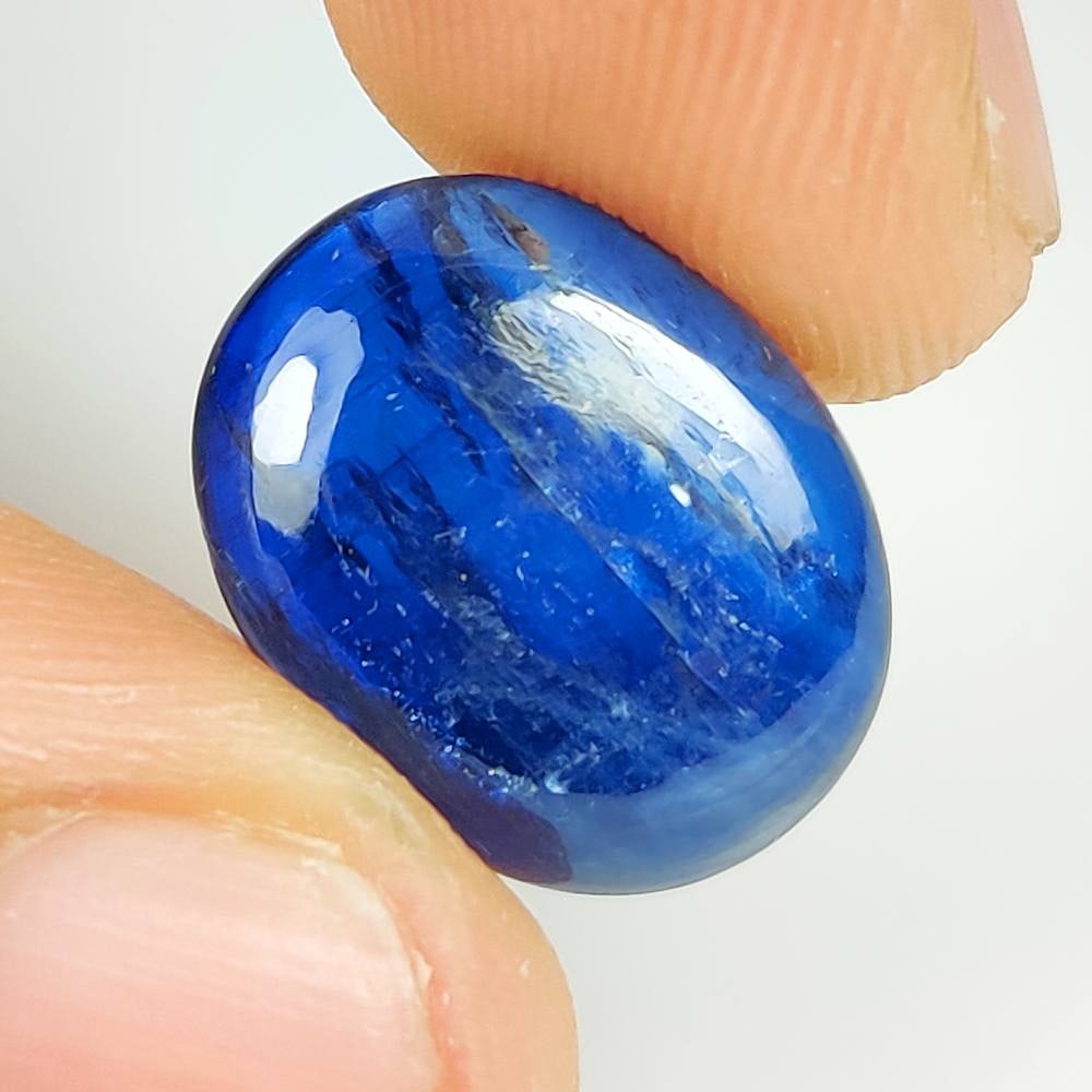 8.06 Ct Natural Blue Kyanite Oval Cab: Weight - 8.06 Ct / Size - 15.50 x 12.20 x 3.80 mm / Shape - Oval cab / Color - Deep Blue / Clarity - Transparent / Origin - India / Treatment - None