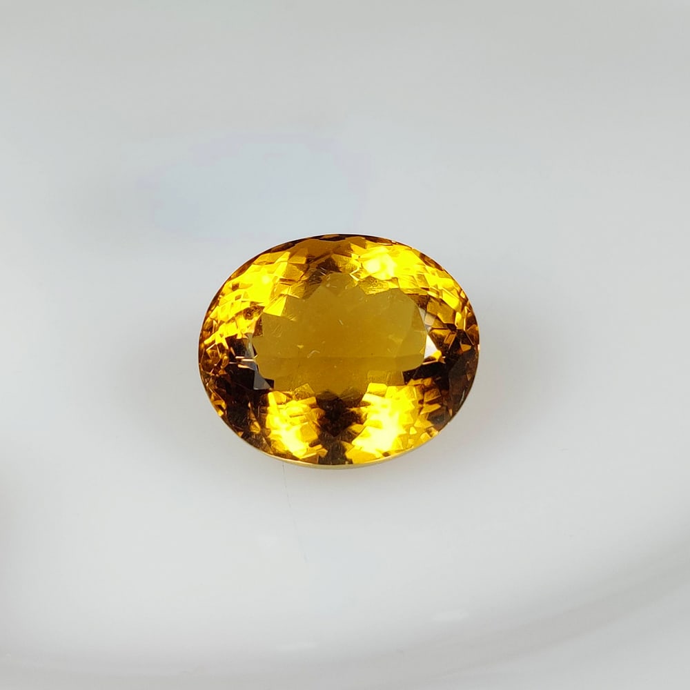 24.43 Ct Natural Yellow Citrine Oval Cut: Weight - 24.43 Ct / Size - 19.40 x 16.20 x 12.30 mm / Shape - Oval Cut / Color - Yellow / Clarity - VVS / Origin - Brazil / Treatment - Heated