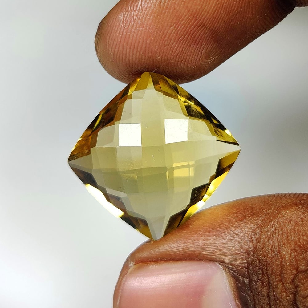 19.66 Ct Natural Yellow Citrine Cushion Cut: Weight - 19.66 Ct / Size - 18.30 x 18.20 x 9.20 mm / Shape - Cushion Cut / Color - Yellow / Clarity - VVS / Origin - Brazil / Treatment - Heated