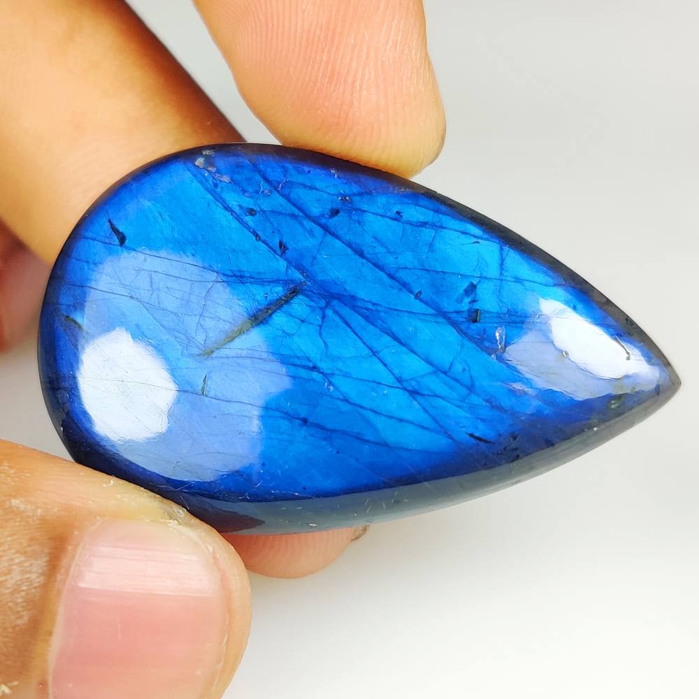59.58 Ct Natural Blue Shaded Labradorite Pear Cab: Weight - 59.58 Ct / Dimensions - 46.00 x 29.00 x 6.30 mm / Shape - Excellent PeaR Cab / Clarity - Opaque / Origin - Africa / Treatment - None