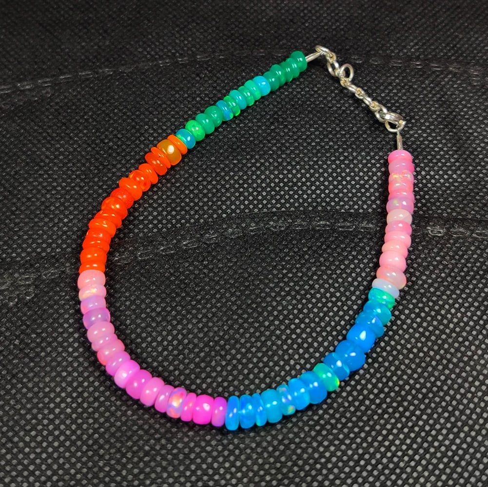 30.71 Ct Natural Multicolor Fire Opal Round Beads Bracelet: Weight - 30.71 Ct / Dimensions - 4.90 - 5.70 mm / 73 Pc's / 9.25" inches / Shape - Round Beads / Color - Multicolor / Clarity - Translucent / Origin - Ethiopia / Treatment - Color Heated