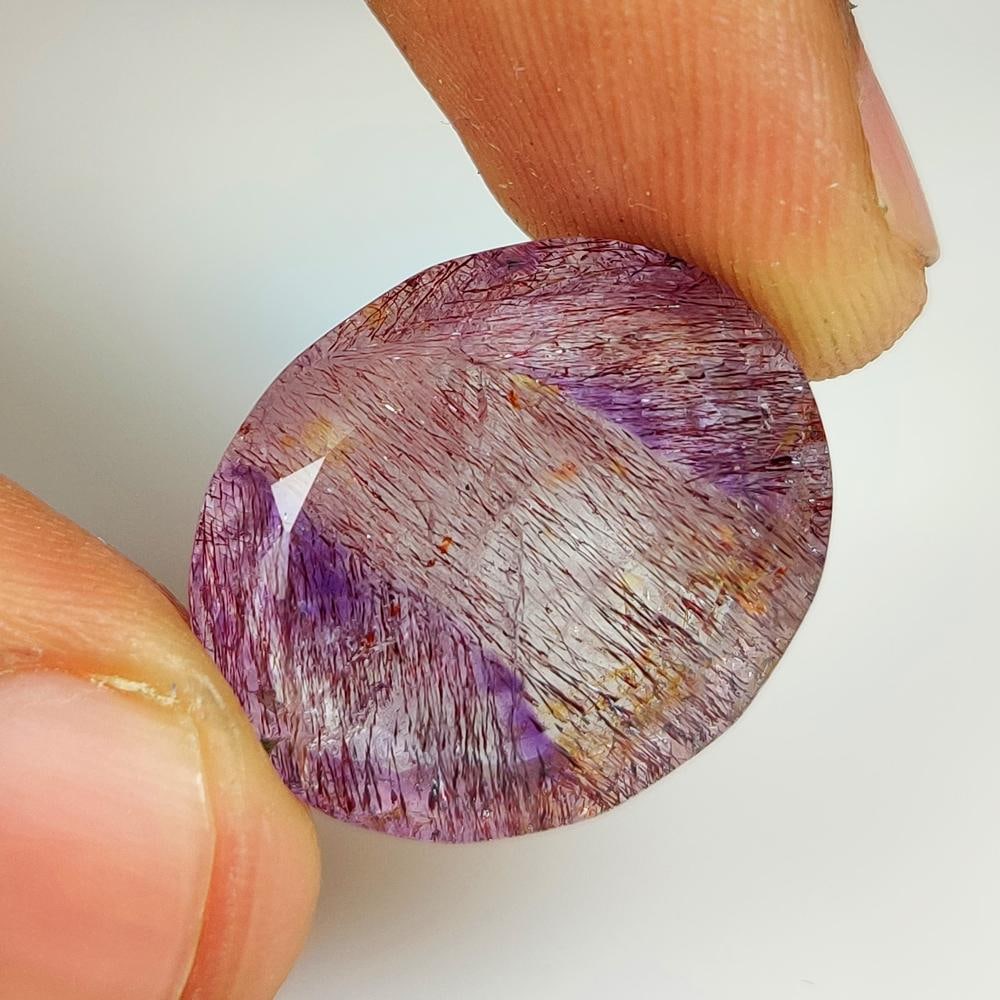 23.60 Ct Natural Rutile Amethyst Quartz Oval Cut: Weight - 23.60 Ct / Size - 22.00 x 17.90 x 8.50 mm / Shape - Oval Cut / Clarity - Transparent / Origin - Norway / Treatment - None