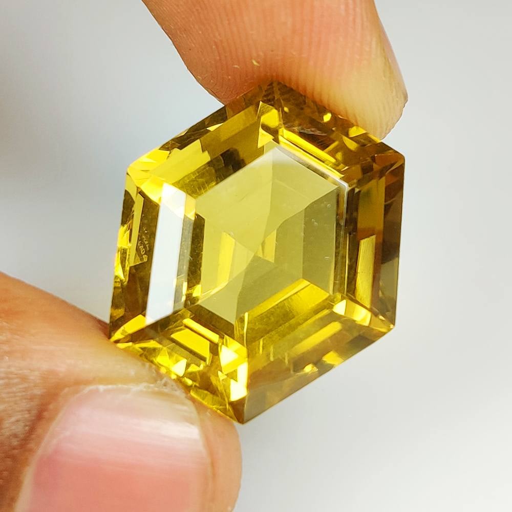 27.91 Ct Natural Citrine Hexagon Cut: Weight - 27.91 Ct / Dimensions - 22.00 x 20.50 x 12.50 mm / Shape & Cut - Hexagon Cut / Color - Greenish Yellow / Transparency - Transparent / Comments - Unheated
