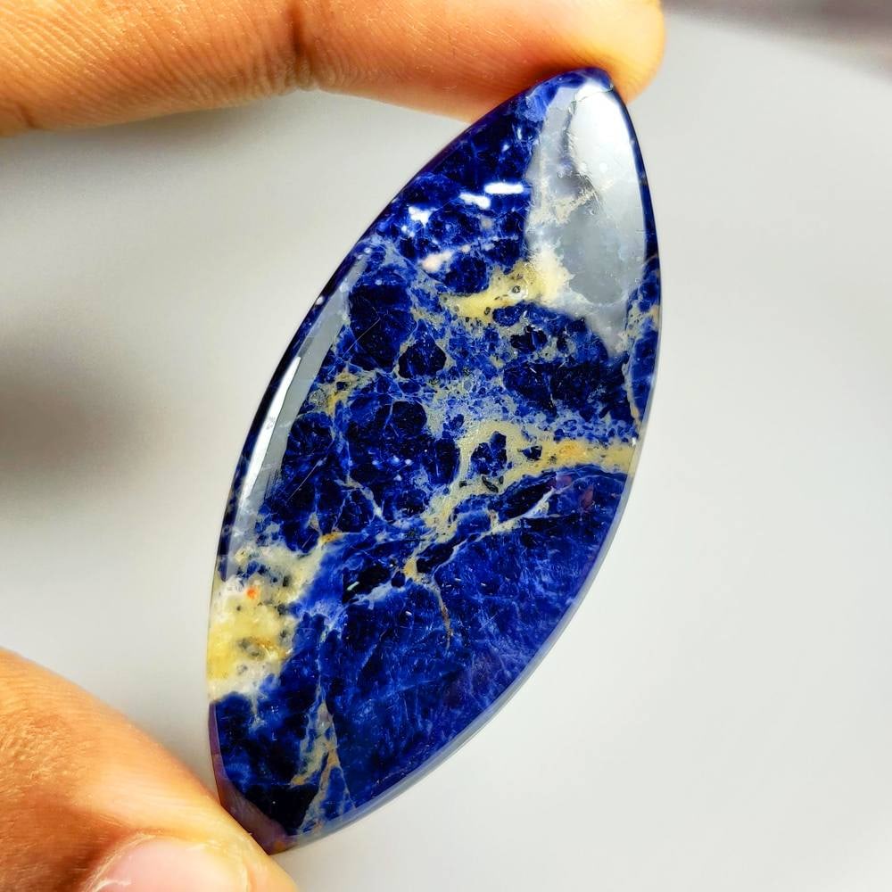 70.63 Ct Natural Blue Sodalite Marquise Cab: Weight - 70.63 Ct / Size - 60.00 x 27.00 x 6.50 mm / Shape - Marquise Cab / Clarity - Opaque / Origin - Russia / Treatment - None