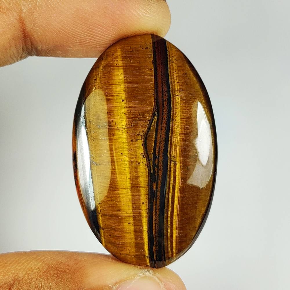 53.71 Ct Natural Tiger Eye Oval Cab: Weight - 53.71 Ct / Dimensions - 41.00 x 26.00 x 6.00 mm / Top Class Quality / Oval Cab / Origin - Burmese / Comments - None