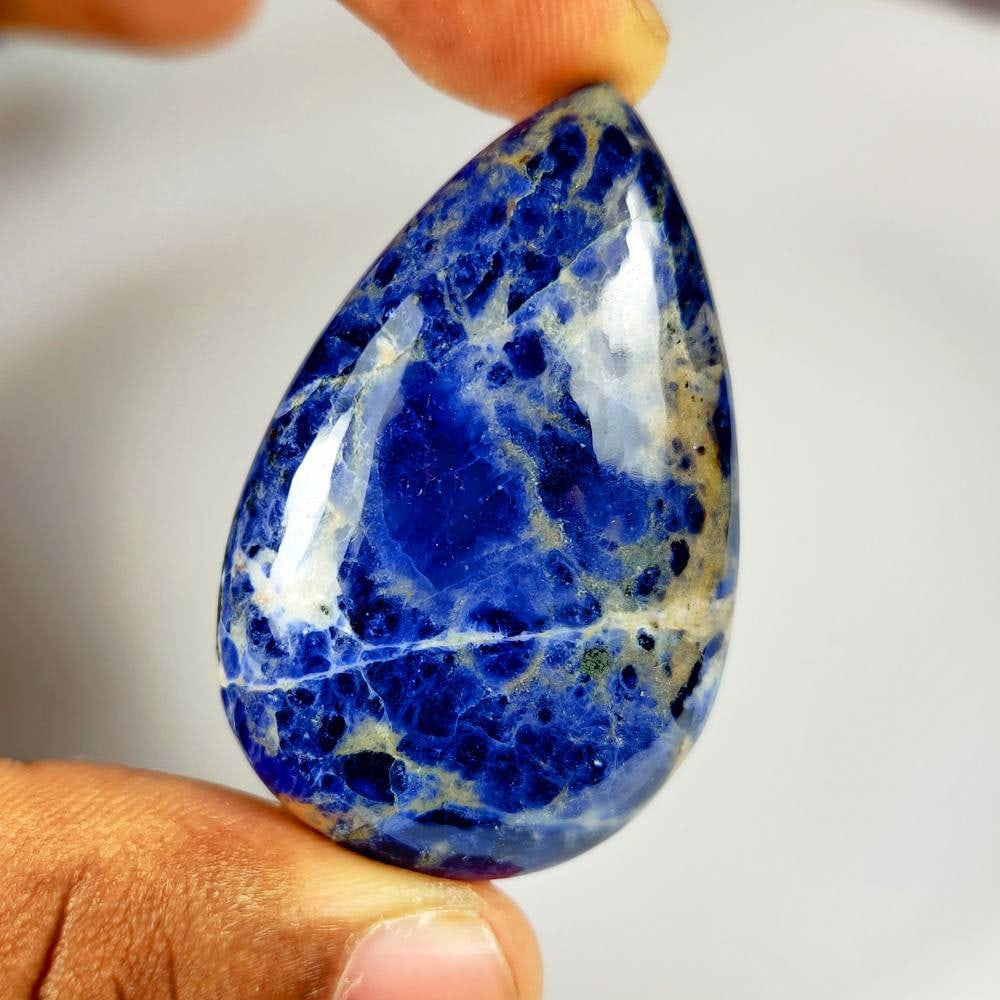 95.54 Ct Natural Blue Sodalite Pear Cab: Weight - 95.54 Ct / Size - 49.00 x 32.00 x 9.70 mm / Shape - Pear Cab / Clarity - Opaque / Origin - Russia / Treatment - None