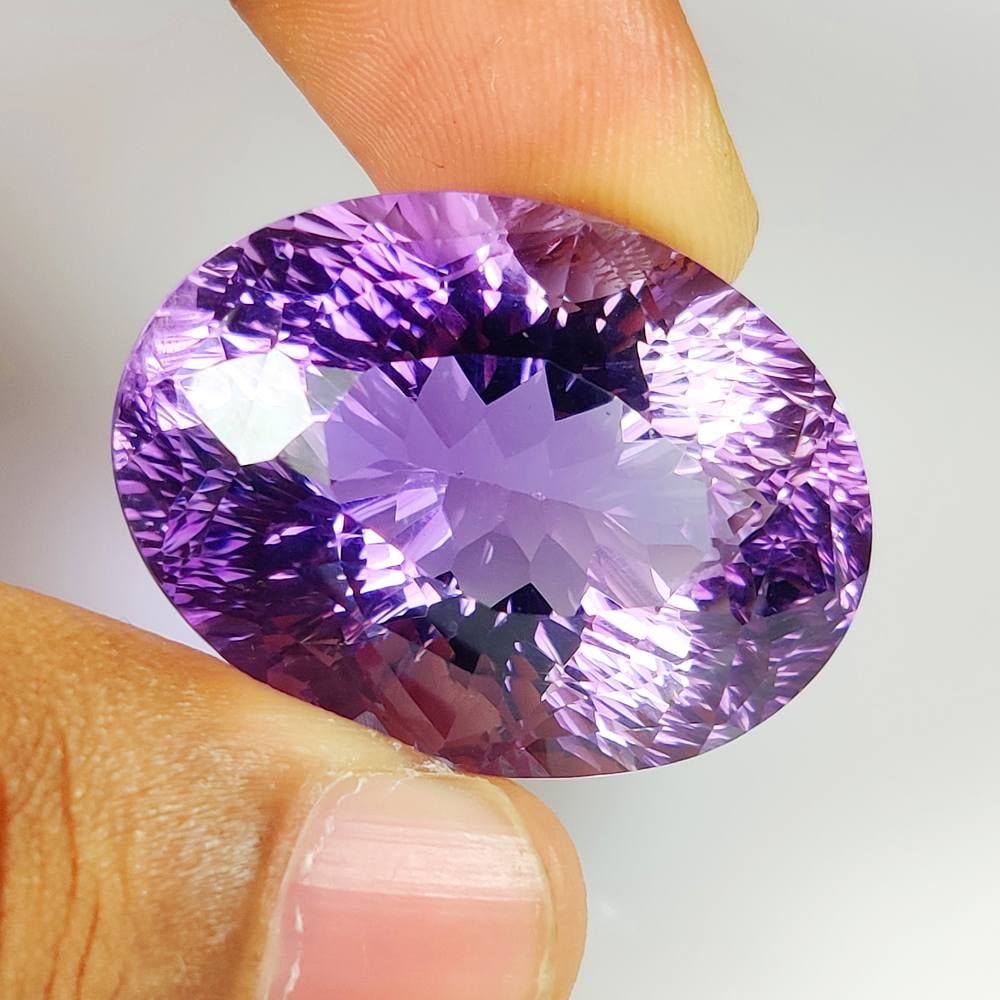 71.85 Ct Natural Purple Amethyst Oval Cut: Weight - 71.85 Ct / Dimensions - 33.00 x 25.00 x 17.40 mm / Shape - Oval Cut / Color - Purple / Clarity - VVS / Origin -Brazil / Treatment - Heated