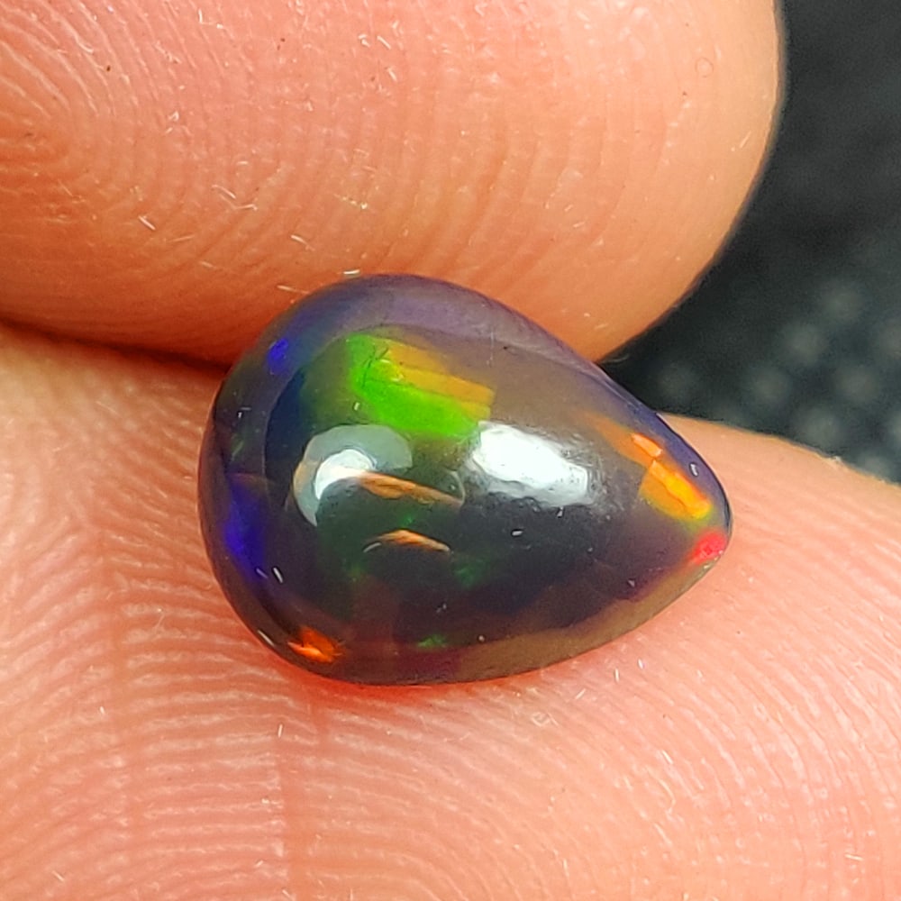 1.21 Ct Natural Black Flashing Fire Opal Pear Cab (1 of 3)