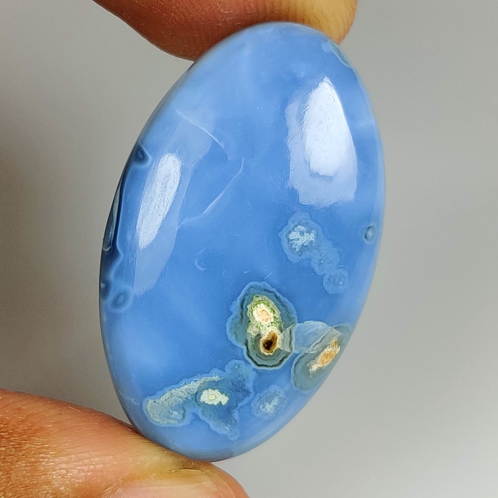 23.95 Ct Natural Blue Opal OVal cab: Weight - 23.95 Ct / Dimensions - 32.00 x 18.50 x 6.30 mm / Shape - OVal cab / Clarity - Opaque / Origin - Peru / Treatment - None