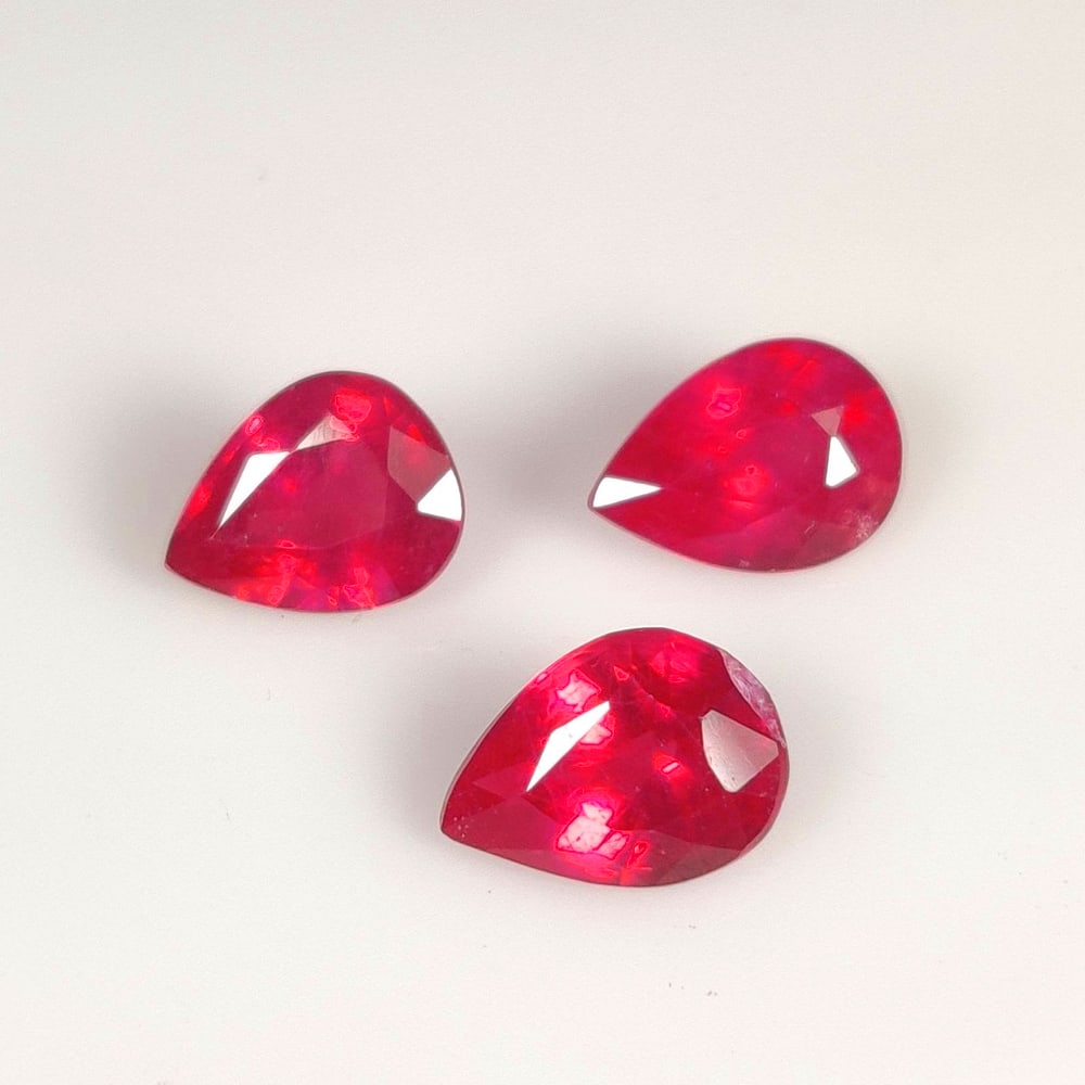 4.49 Ct Natural Pinkish Red Ruby Pear Cut Set: Weight - 4.49 Ct / Size - 7.8x6.1 - 8.5x6.3 mm / 3 PC's / Shape - Pear Cut / Color - Red / Clarity - SI / Origin - Mozambique / Treatment - Color Enhanced by Glass Filling