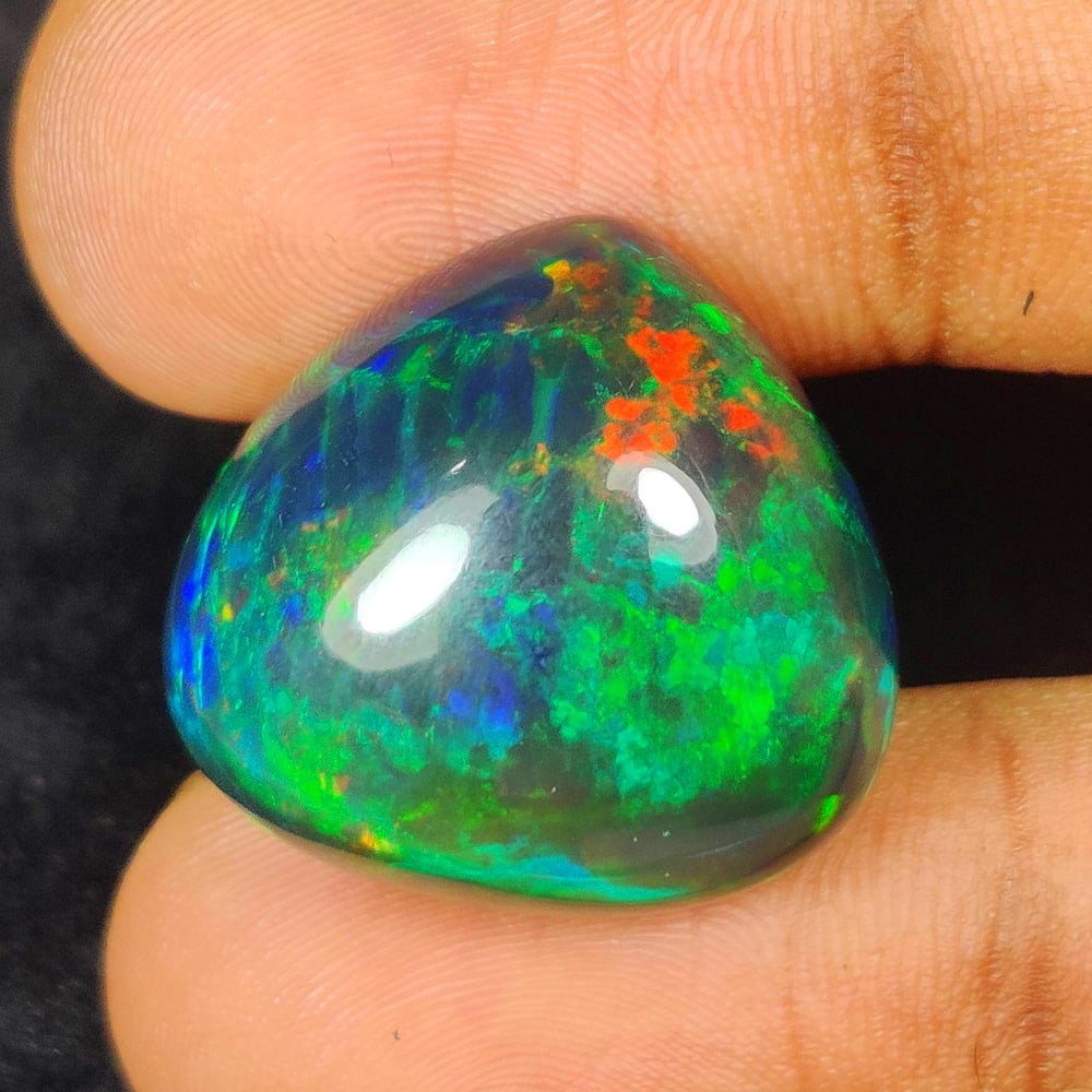 22.29 Ct Natural Black Flash Fire Opal Pear Cab: Weight - 22.29 Ct / Dimensions - 22.00 x 20.60 x 10.30 mm / Shape - Pear Cab / Color - Black / Clarity - Translucent / Origin - Ethiopia / Treatment - Color Smoked