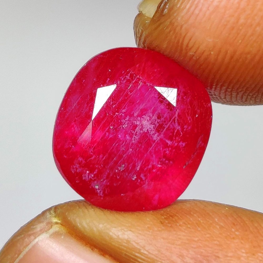 12.21 Ct Natural Pinkish Red Ruby Cushion Cut: Weight - 12.21 Ct / Dimensions - 12.20 x 11.50 x 9.40 mm / Shape - Cushion Cut / Color - Red / Clarity - SI / Origin - Mozambique / Comments - Color Enhanced by Glass Filling