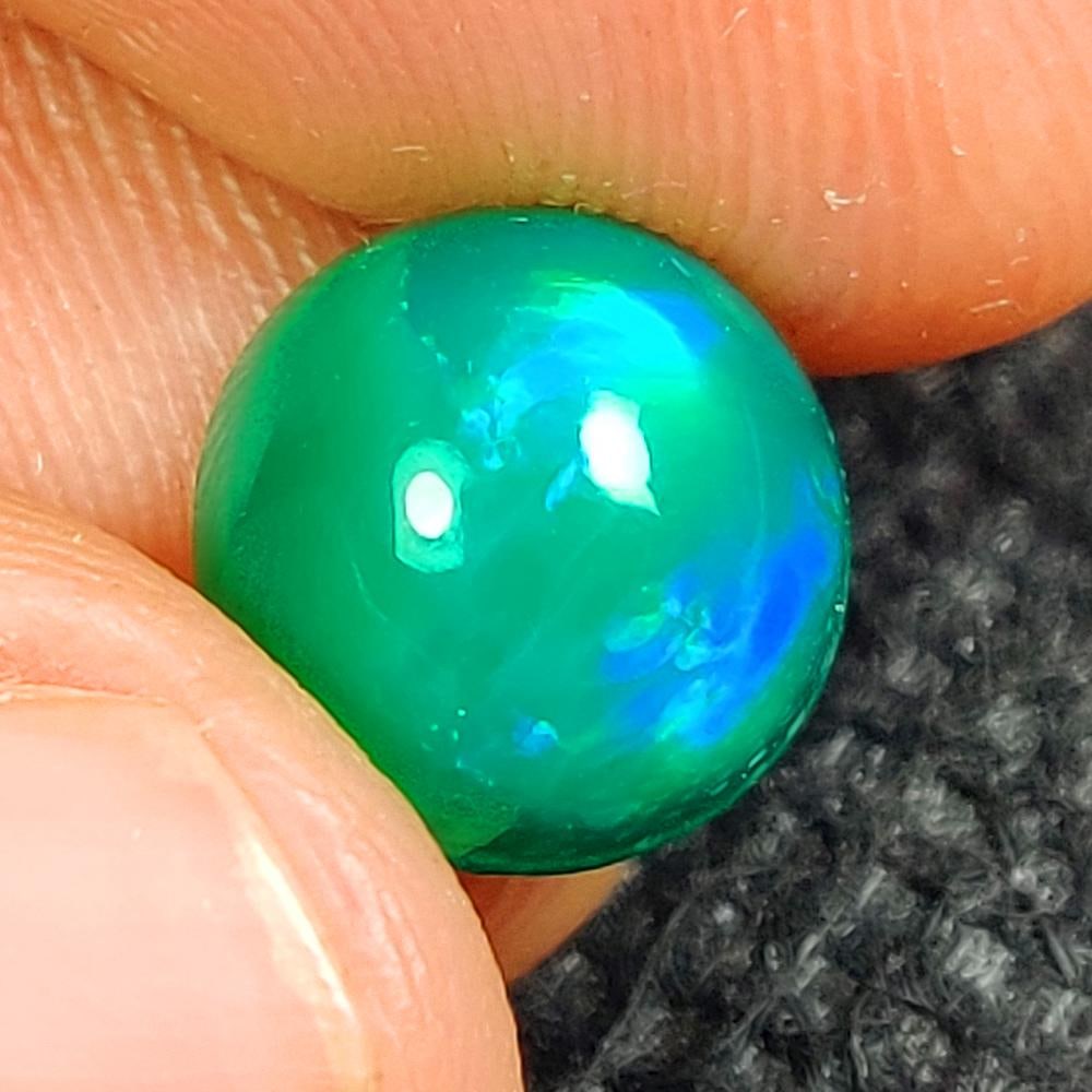 2.16 Ct Natural Green Fire Opal Round Cab: Weight - 2.16 Ct / Dimensions - 9.40 x 9.20 x 5.60 mm / Shape - Round Cab / Color - Green / Clarity - Translucent / Origin - Ethiopia / Treatment - Color Heated