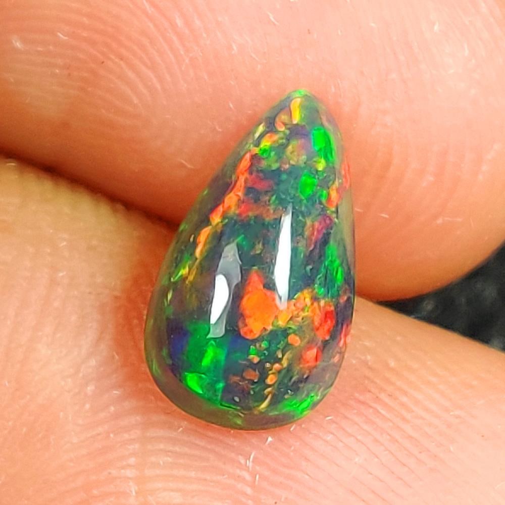 1.35 Ct Natural Black Flashing Fire Opal Pear Cab (1 of 2)