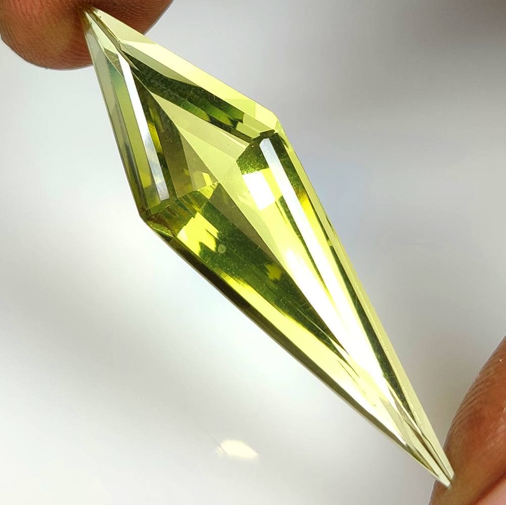 18.89 Ct Natural Lemon Quartz Fancy Cut: Weight - 18.89 Ct / Dimensions - 47.00 x 12.70 x 8.70 mm / Shape - Fancy Cut / Clarity - VVS / Origin - Brazil / Treatment - Heated