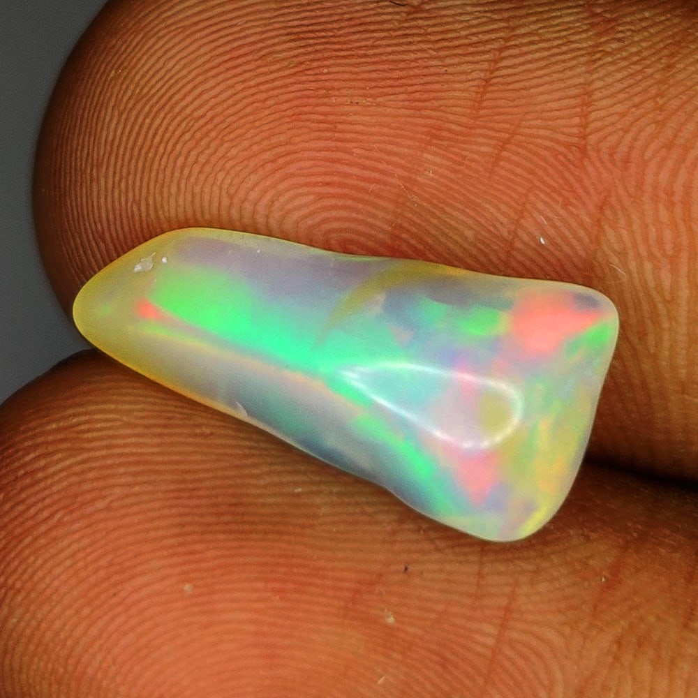 2.62 Ct Natural Multicolor Welo Opal Top Fire Solid Rough: Weight - 2.62 Ct / Size - 17.00 x 8.40 x 5.00 mm / Shape - Solid Rough Cab / Color - Multicolor / Clarity - Translucent / Origin - Ethiopia / Treatment - None