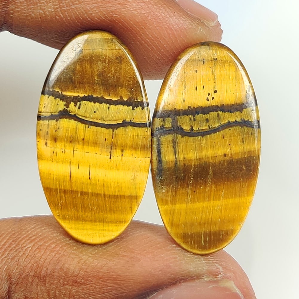 18.44 Ct Natural Tiger Eye OVal Cab Pair: Weight - 18.44 Ct / Size - 25.00 x 12.80 x 3.10 mm / 2 pc's / Shape - OVal Cab / Color - Golden Brown / Clarity - Opaque / Origin - Burma / Treatment - None