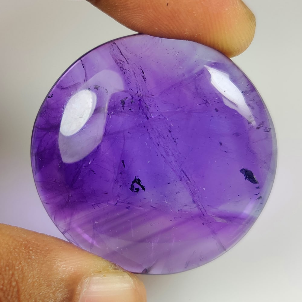 111.39 Ct Natural Purple Amethyst JUMBO Round Cab: Weight - 111.39 Ct / Size - 39.0 0x 39.00 x 10.20 mm / Shape - Round Cab / Color - Purple / Clarity - Transparent / Origin -Brazil / Treatment - Heated
