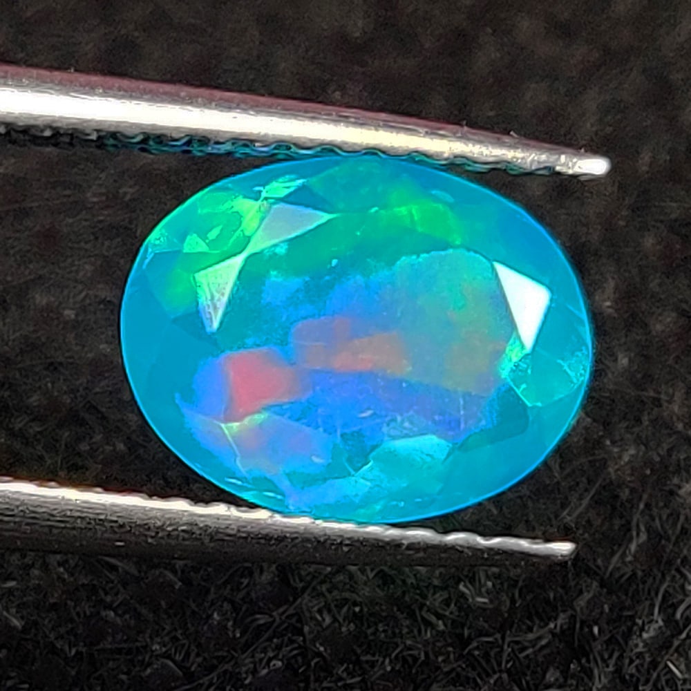1.29 Ct Natural Blue Fire Opal Oval Cut: Weight - 1.29 Ct / Dimensions - 9.00 x 7.10 x 4.60 mm / Shape - Oval Cut / Color - Blue / Clarity - Translucent / Origin - Ethiopia / Treatment - Heated