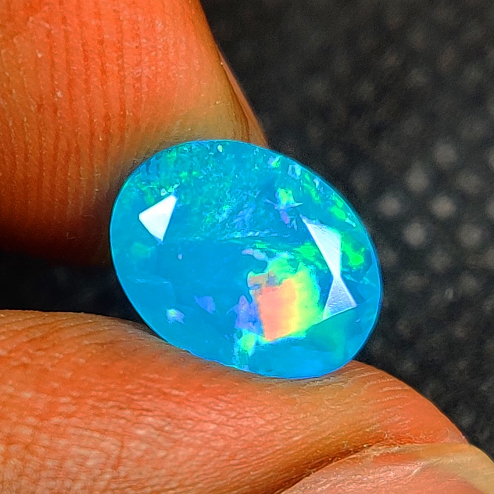 1.36 Ct Natural Blue Fire Opal Oval Cut: Weight - 1.36 Ct / Size - 10.00 x 7.80 x 4.40 mm / Shape - Oval Cut / Color - Blue / Transparency - Translucent / Origin - Ethiopia / Treatment - Color Heated