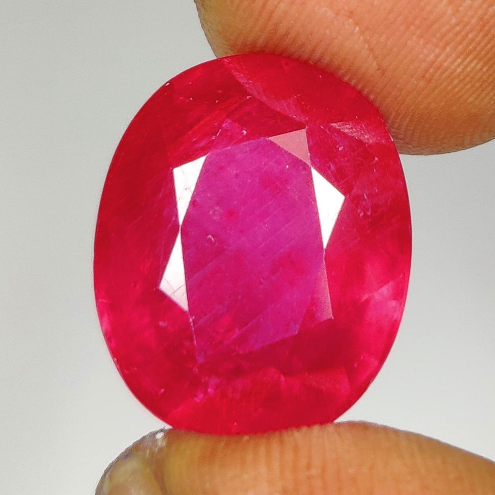 15.32 Ct Natural Pinkish Red Ruby Cushion Cut: Weight - 15.32 Ct / Dimensions - 15.90 x 13.00 x 7.80 mm / Shape - Cushion Cut / Color - Pinkish Red / Clarity - SI / Origin - Mozambique / Treatment - Color Enhanced by Glass Filling