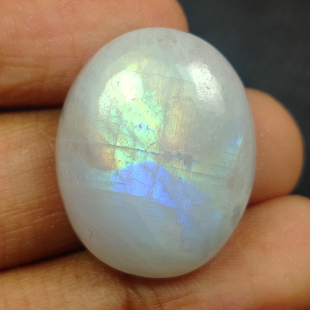 21.14 Ct Natural White Rainbow Moonstone Oval Cab: Weight - 21.14 Ct / Size - 22.10 x 17.70 x 6.40 mm / Shape - Oval Cab / Clarity - Semi-Transparent / Origin - India / Treatment - None
