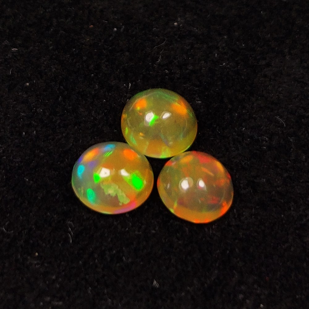 0.89 Ct Natural Multicolor Welo Opal Round Cab Set: Weight - 0.89 Ct / Dimensions - 4.70 - 4.90 mm / 3 Pc's / Shape & Cut - Round Cab / Color - Multicolor / Transparency - Translucent / Origin - Ethiopia / Comments - None