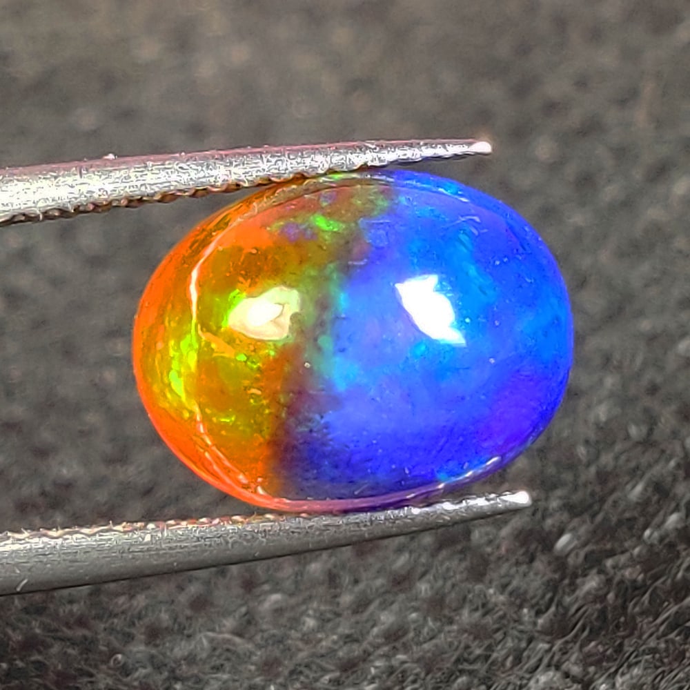 2.89 Ct Natural Bicolor Fire Opal Oval Cab: Weight - 2.89 Ct / Dimensions - 11.30 x 8.70 x 6.30 mm / Shape - Oval Cab / Color - Bicolor / Clarity - Translucent / Origin - Ethiopia / Treatment - Color Heated