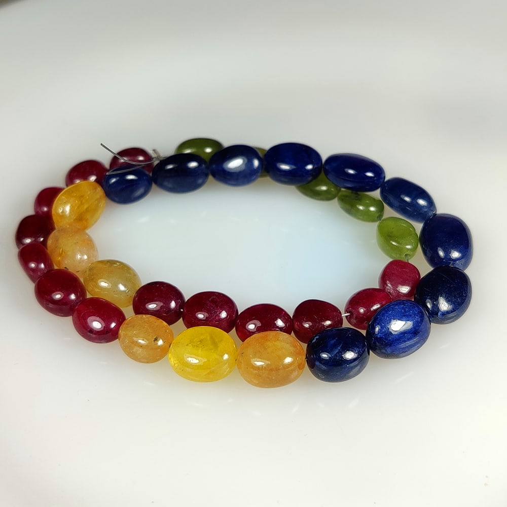 146.84 Ct Natural Multicolor Sapphire Dumbbell Beads: Weight - 146.84 Ct / Size- 7.3x6.4 - 11.4x8.6 mm / 34 Pc's / 12" inches / Shape - Dumbbell Beads / Clarity - SI / Origin - Sri Lanka / Treatment - Standard Heated