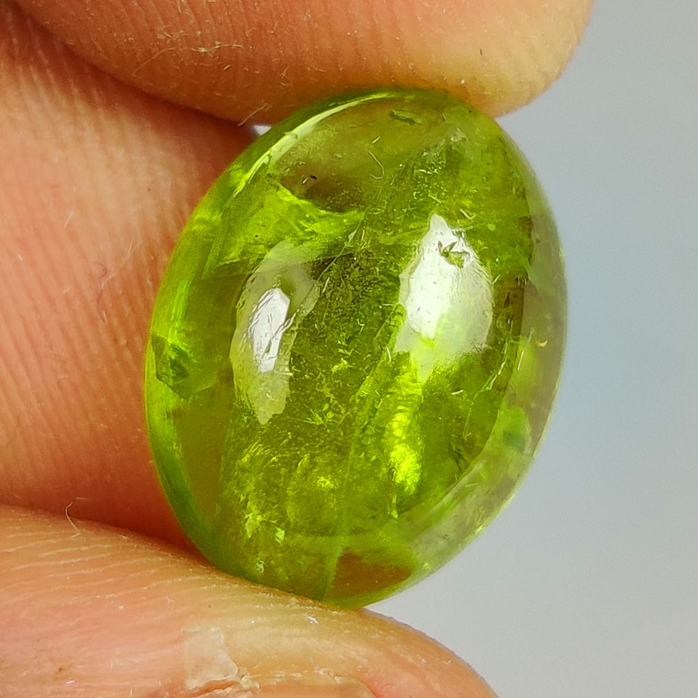 9.22 Ct Natural Green Peridot Oval Cab: Weight - 9.22 Ct / Dimensions - 14.60 x 11.30 x 6.00 mm / Shape - Oval Cab / Color - Green / Clarity - SI / Origin - Pakistan / Treatment - None