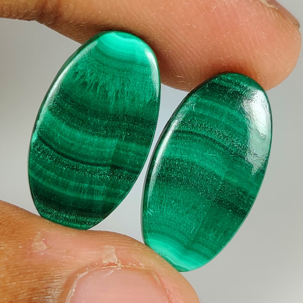24.44 Ct Natural Green Malachite Oval Cab Pair: Weight - 24.44 Ct / Dimensions - 19.80 x 11.20 x 4.00 mm / 2 Pc's / Shape - Oval Cab / Color - Green / Clarity - Opaque / Origin - Russia / Treatment - None