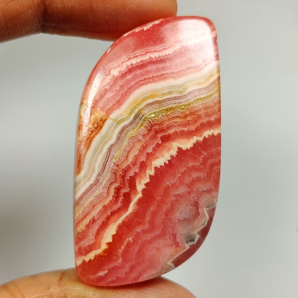 65.64 Ct Natural Rhodochrosite Fancy Cab: Weight - 65.64 Ct / Size - 43.00 x 21.50 x 5.70 mm / Shape - Fancy Cab / Clarity - Opaque / Origin - Brazil / Treatment - None