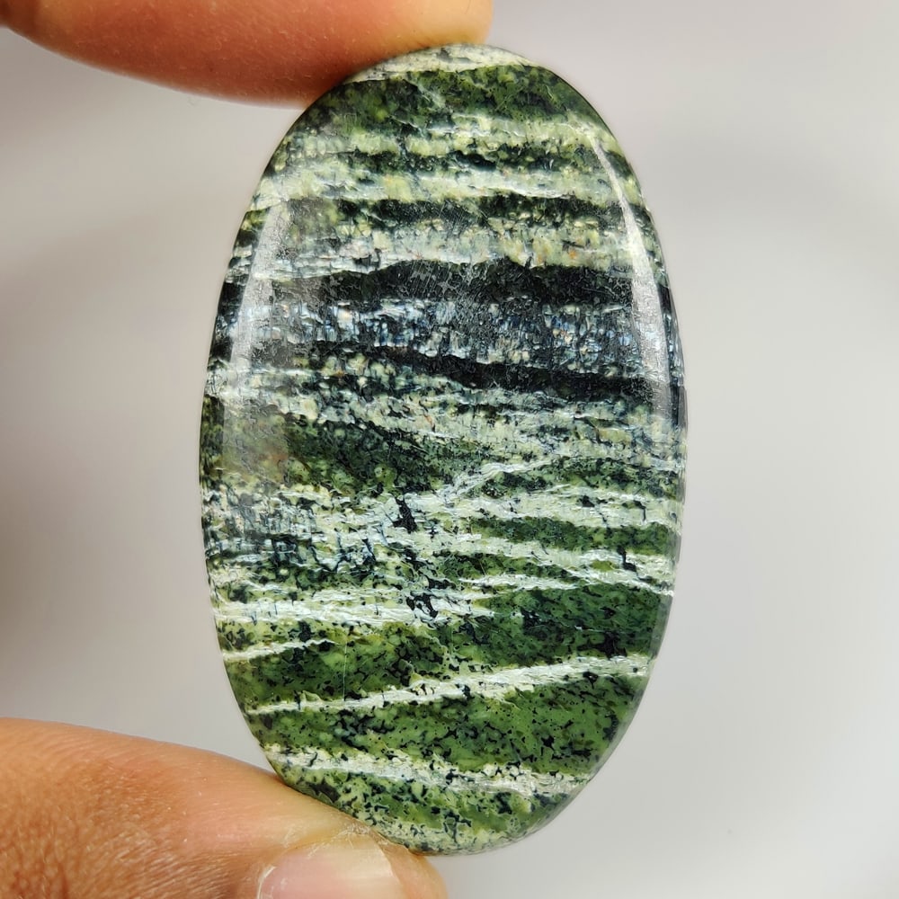 69.54 Ct Natural Green Swiss Opal Oval Cab: Weight - 69.54 Ct / Dimensions - 49.00 x 29.00 x 5.70 mm / Shape - Oval Cab / Clarity - Opaque / Origin - Brazil / Treatment - None