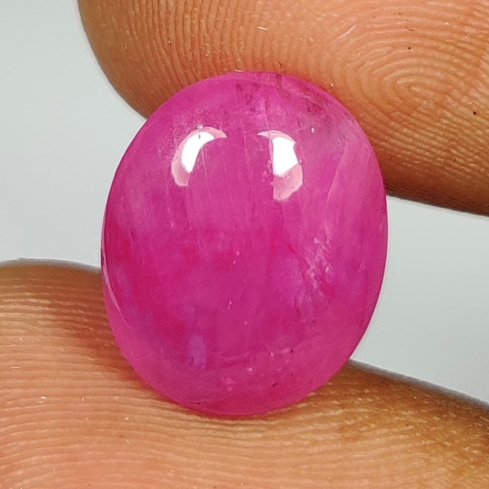 6.22 Ct Natural Pinkish Red Ruby Oval Cab: Weight - 6.22 Ct / Dimensions - 13.00 x 10.00 x 5.00 mm / Shape - Oval Cab / Color - Pinkish Red / Clarity - SI / Origin - Mozambique / Treatment - Color Enhanced by Glass Filling